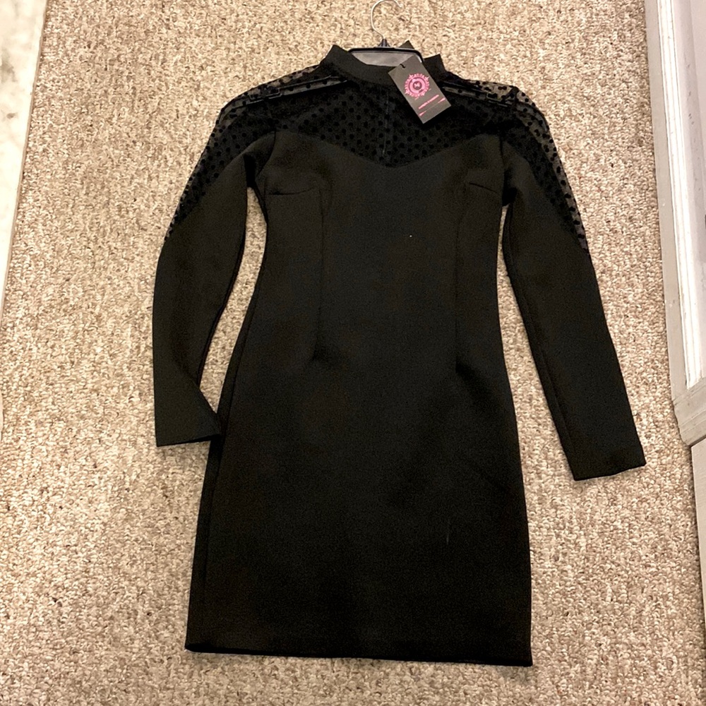 Little black dress. Sheer polka dot mock neck with sheer details down arms